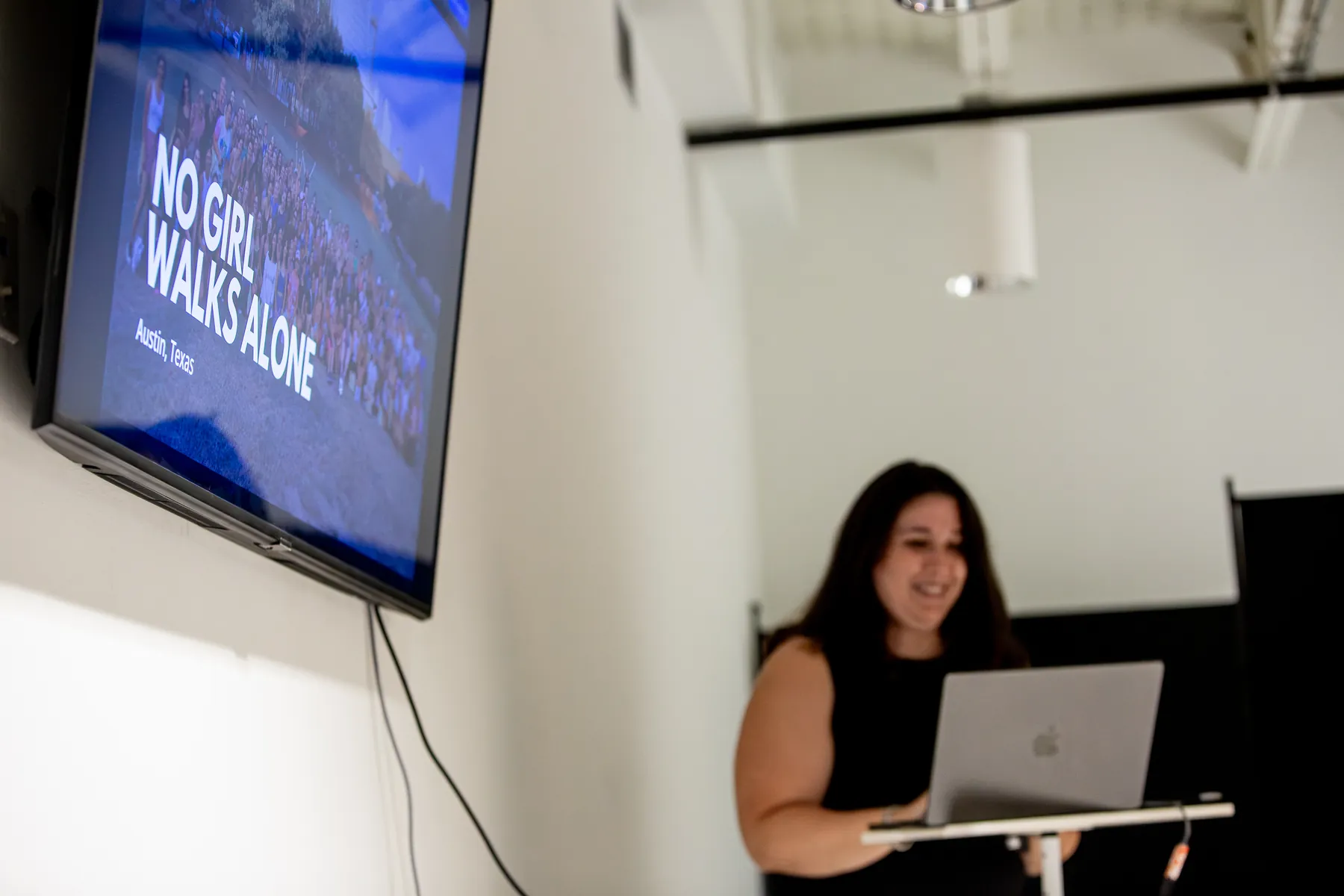 A No Girl Walks Alone representative presents the organization's work