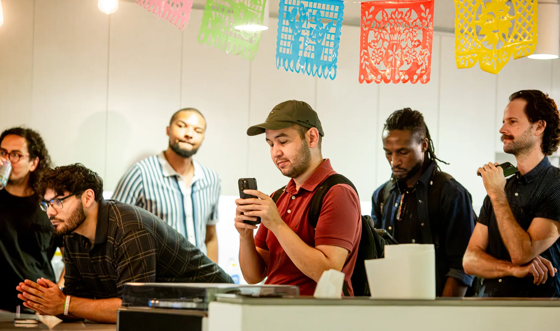Austin attendees listening beneath colorful papel picado during the presentations